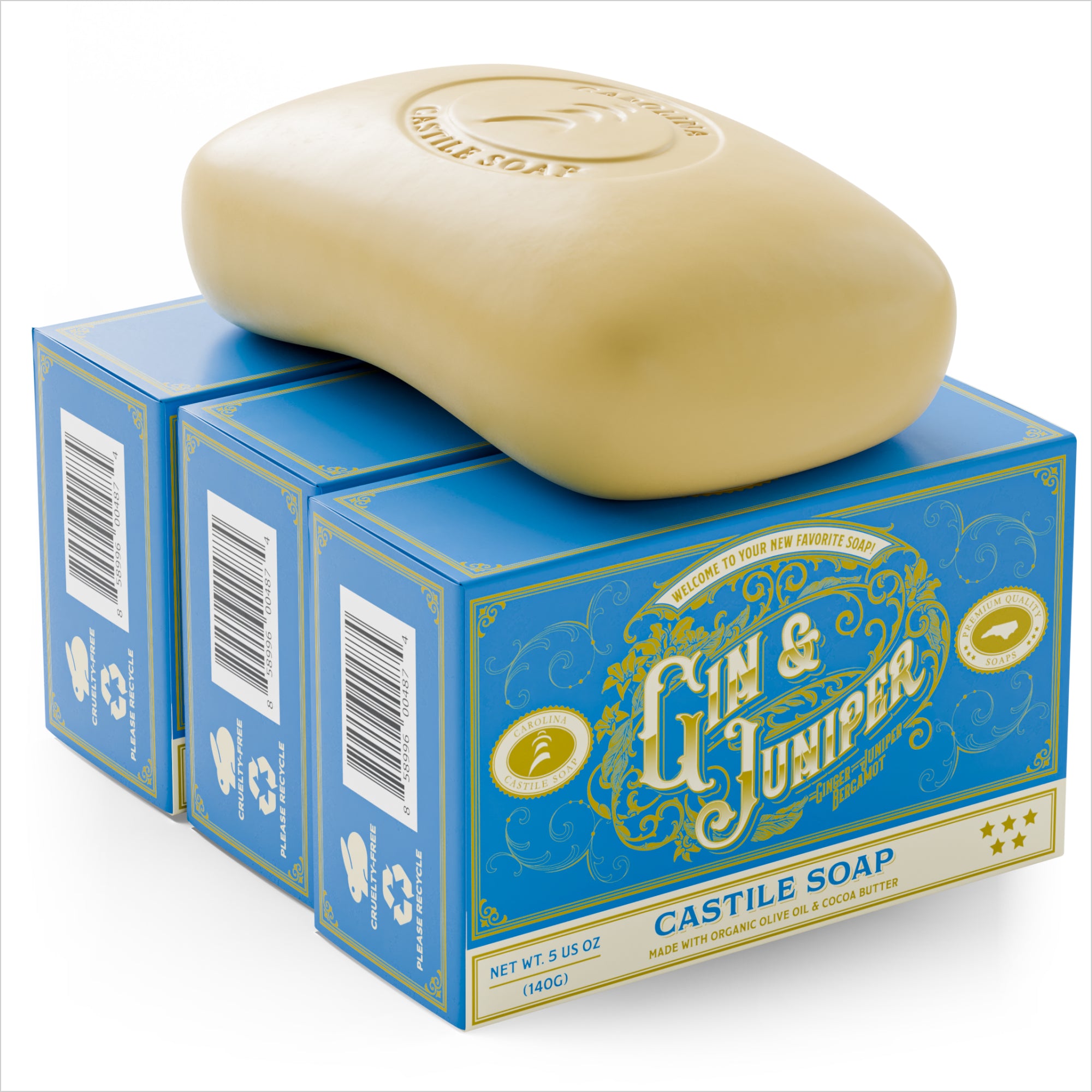 single bar of Castile Soap with Carolina Castile Soap logo stamped into it. The bar is sitting on top of 3 bar soap cartons arranged against each other. The cartons are gin blue with the words "gin & juniper" and "Castile Soap" on it.