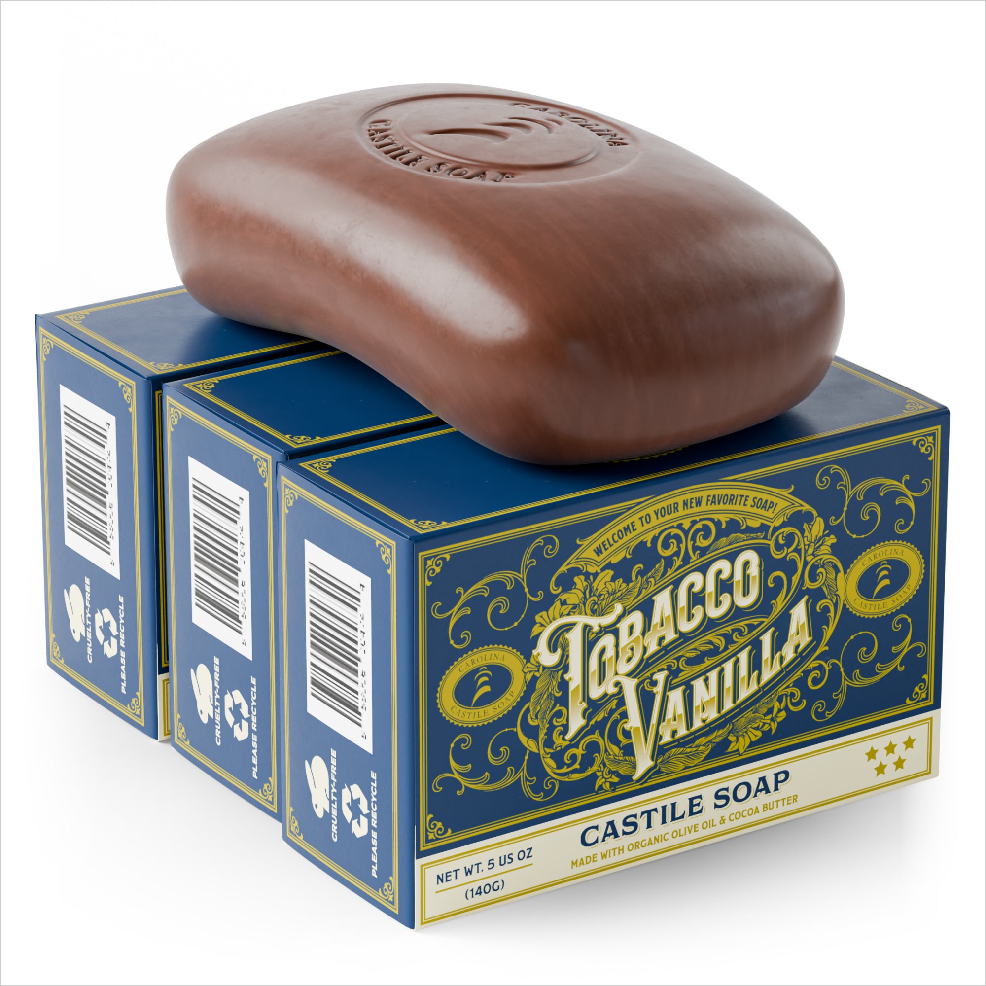 single bar of Castile Soap with Carolina Castile Soap logo stamped into it. The bar is sitting on top of 3 bar soap cartons arranged against each other. The cartons are navy blue with the words "tobacco vanilla" and "Castile Soap" on it.