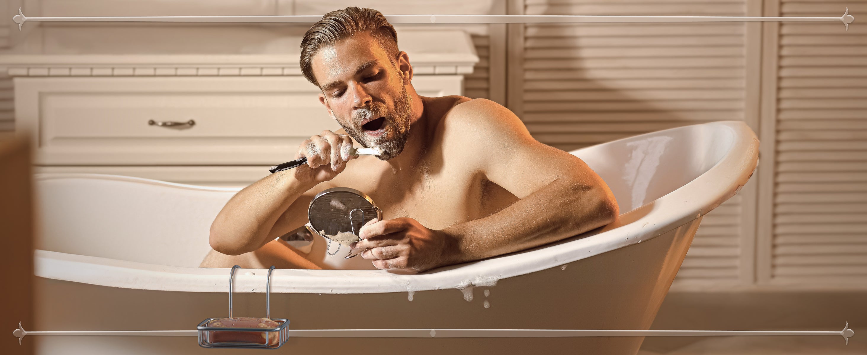 man shaving in the bathtub with bar of castile soap hanging on the edge of bathtub