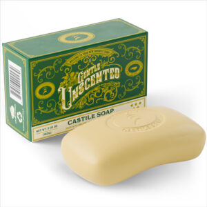 Single bar of unscented castile soap with green butter carton sitting upright behind it.