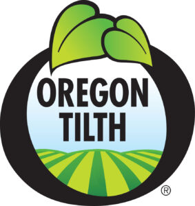 A logo for Oregon Tilth containing image of field of crops with green leaf above a circle.